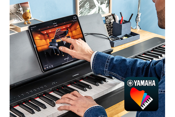 The Yamaha “Smart Pianist” app icon, together with a tablet placed on the music stand of the P-223