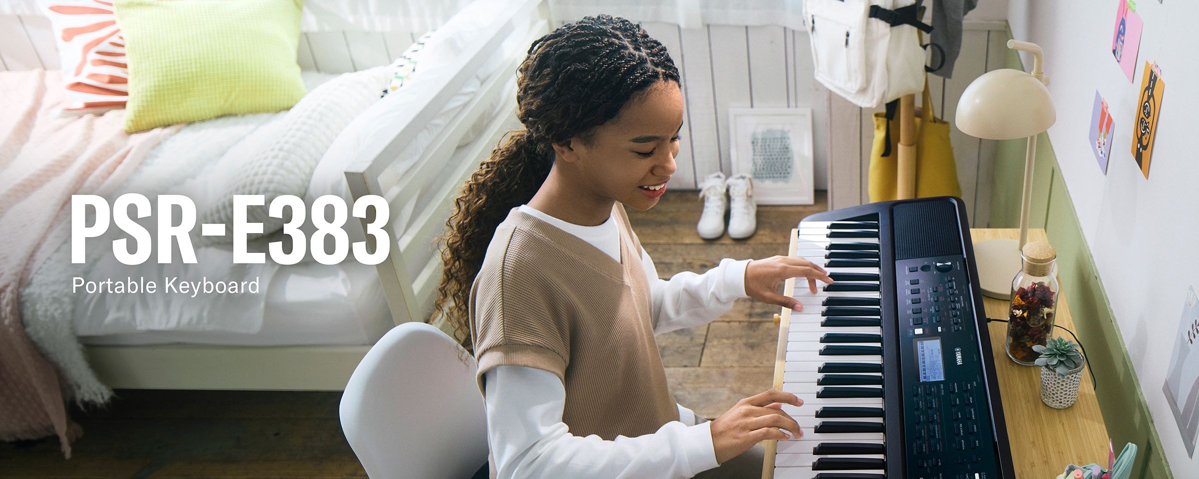 Girl happily playing the PSR-E383 on her desk.