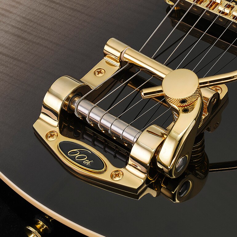 A luxurious flame maple top in Noble Black finish, with a tremolo unit adorned by a special 60th Anniversary logo.