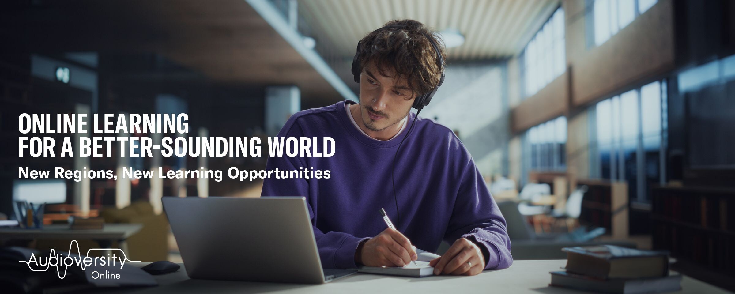 Key visual for Audioversity Online: a man focused on an online training session.