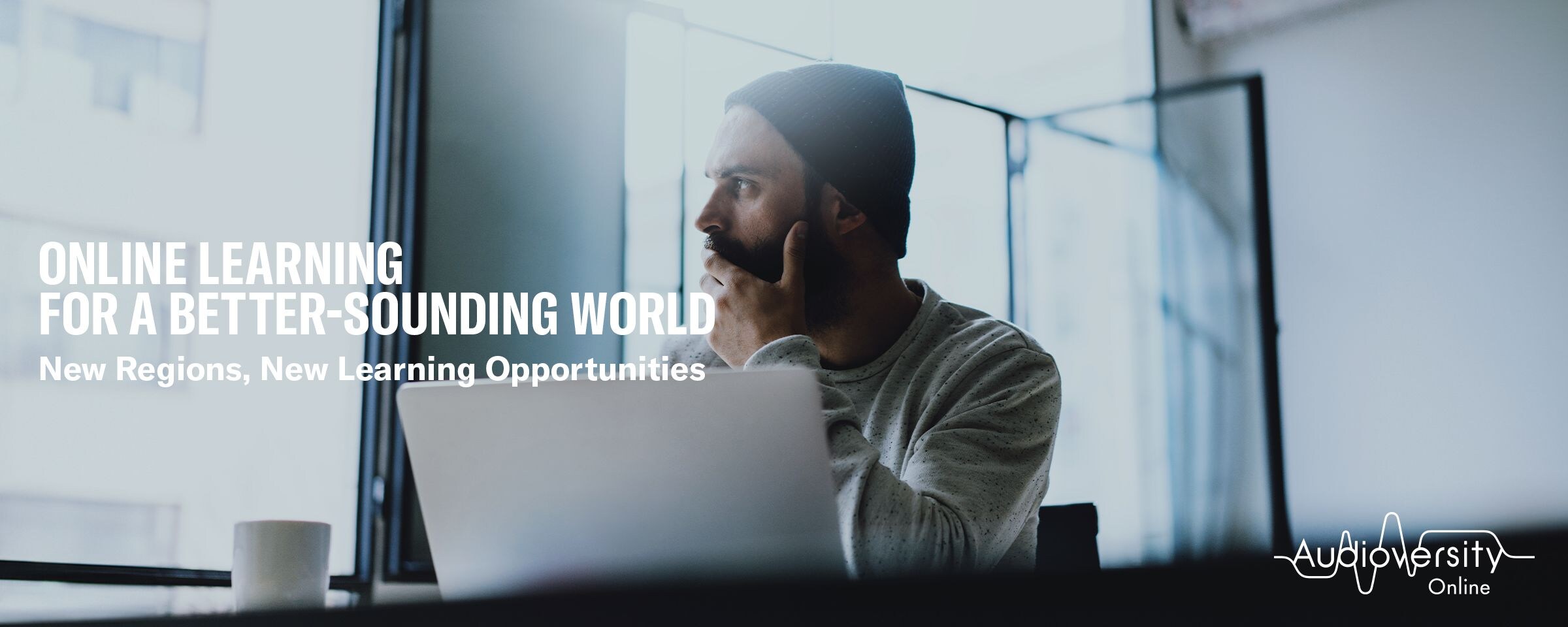 Key visual for Audioversity Online: a man wearing a hat with a serious expression.